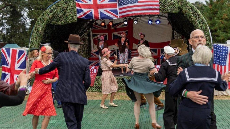 People in costume attending 1940s event