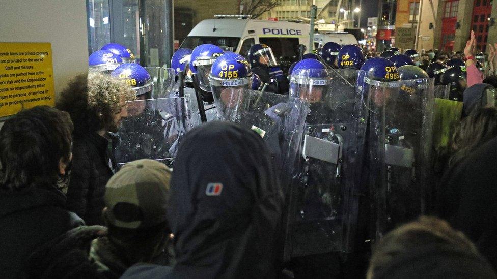 Riot police and protesters