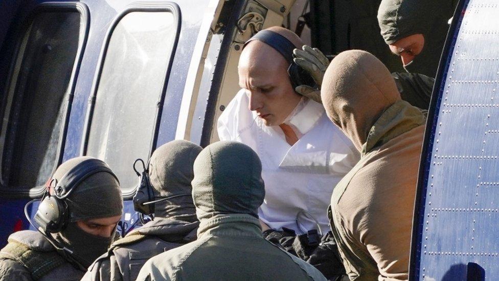 Stephan Balliet being taken out of a helicopter by German special forces