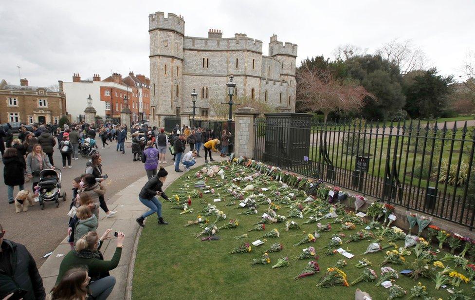 Mourners gather outside Windsor Castle after Britain's Prince Philip, husband of Queen Elizabeth, died at the age of 99, in Windsor, near London. 10 April 2020.