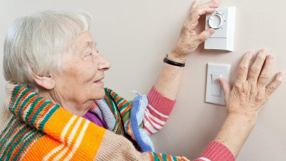 woman using thermostat