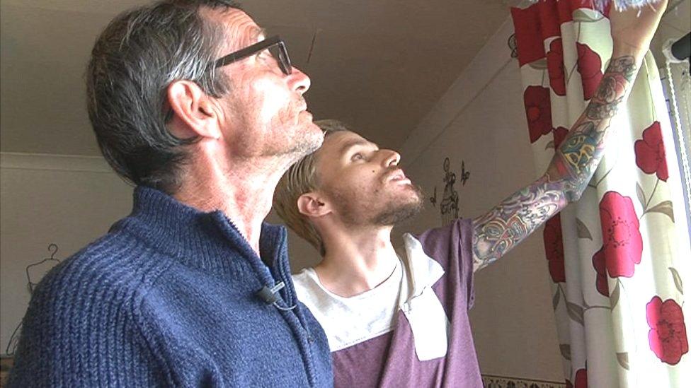 Chris Stephens and son Jonathan look at the damp ceiling