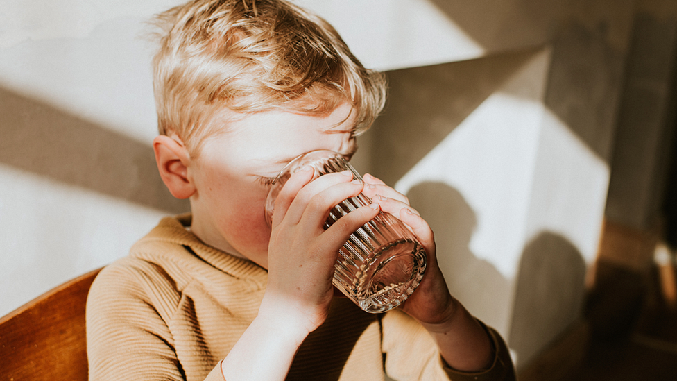 Boy drinking a glass of water