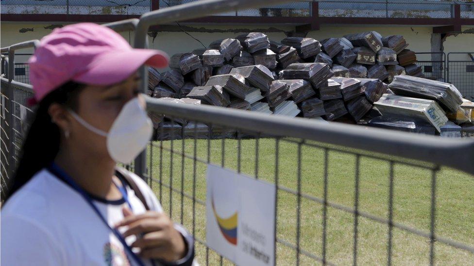 A woman looks at a pile of empty coffins at Maximino Puertas stadium in Pedernales, after an earthquake struck off Ecuador"s Pacific coast, April 19, 2016