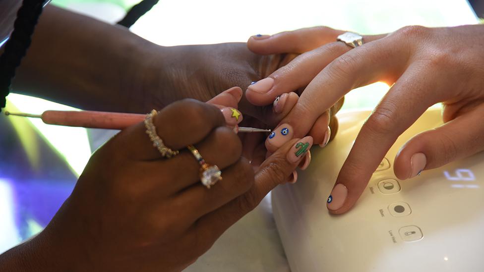 Kadimah Aaliyah works on Kwasi Ritchie-Row's nails