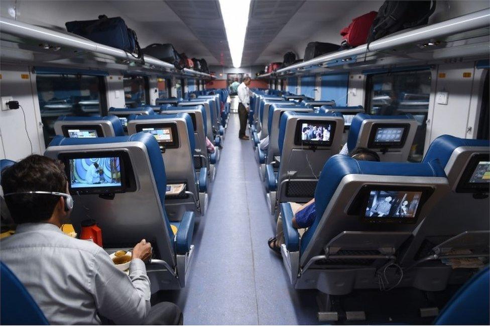 In this photograph taken on May 22, 2017, Indian passengers travel onboard the Tejas Express luxury train during its first journey between Mumbai and Goa in Mumbai