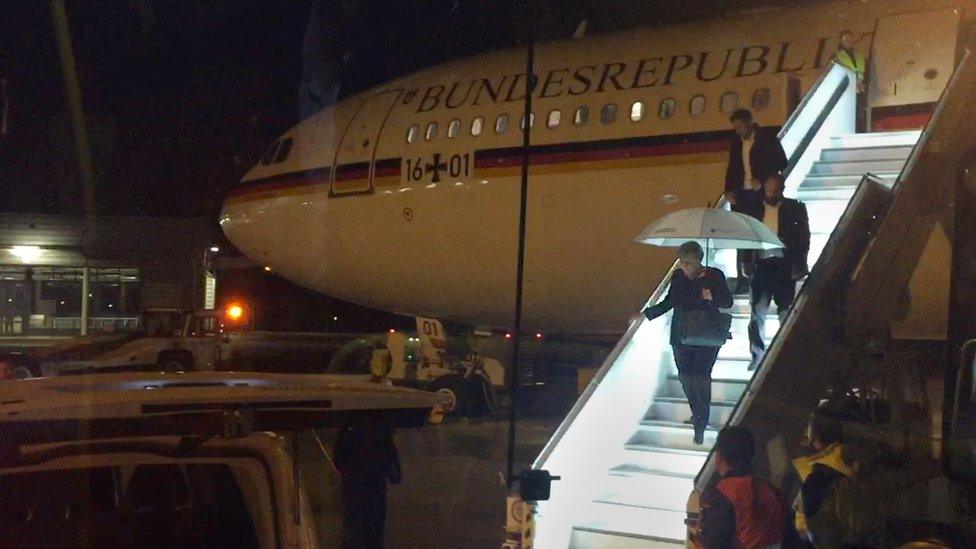 Angela Merkel emerges at Cologne airport from the Airbus A340 taking her to the summit