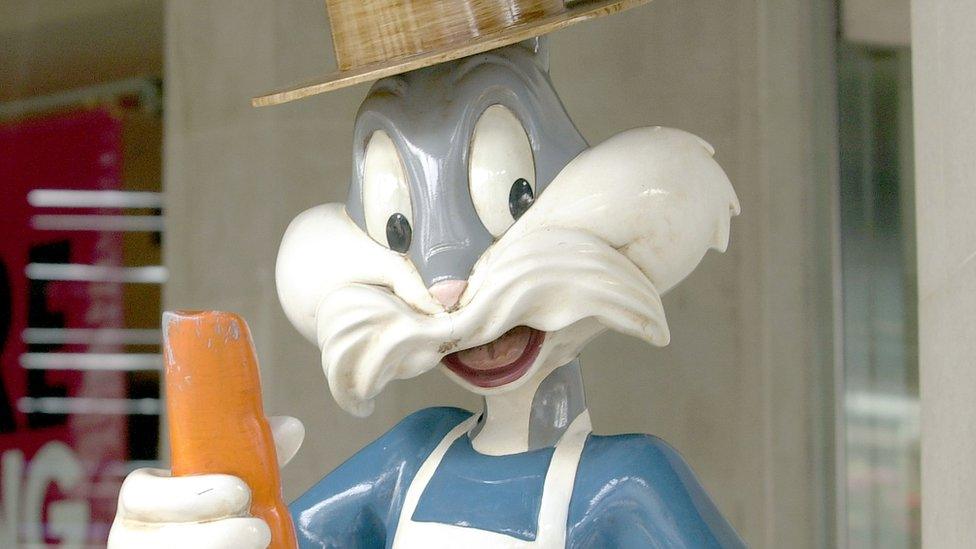 A statue of cartoon character Bugs Bunny, dressed as a fisherman, is displayed outside of a Warner Bros. Studio Store July 9, 2001 on Pier 39 in San Francisco, CA