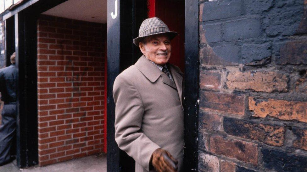 A man enters the stadium through a turnstile