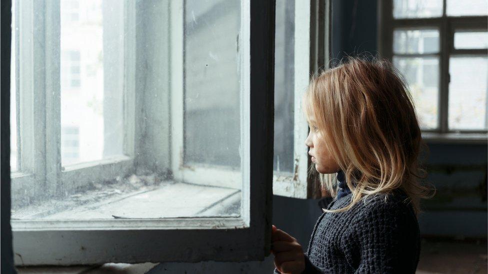 Young girl at window