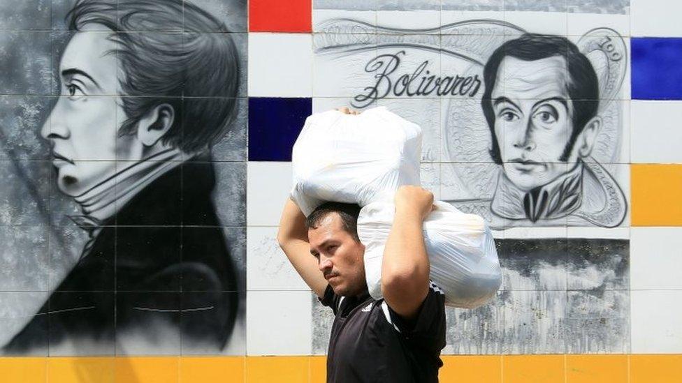 A Venezuelan citizen returns home after buying supplies in Colombia, in San Antonio, Venezuela, 13 August 2016.