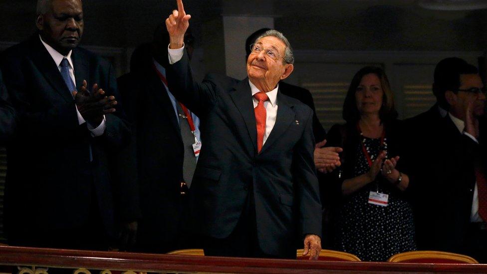 Cuba"s President Raul Castro gestures to the audience as he takes his seat before U.S. President Barack Obama makes a speech to the Cuban people in the Gran Teatro de la Habana