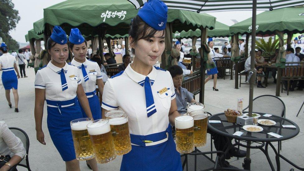 Waitresses dressed in air stewardess uniforms at the 2016 Pyongyang Beer Festival