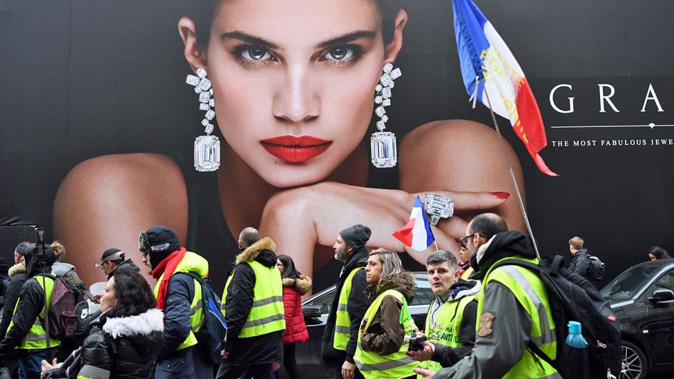 Paris protesters in front of advert