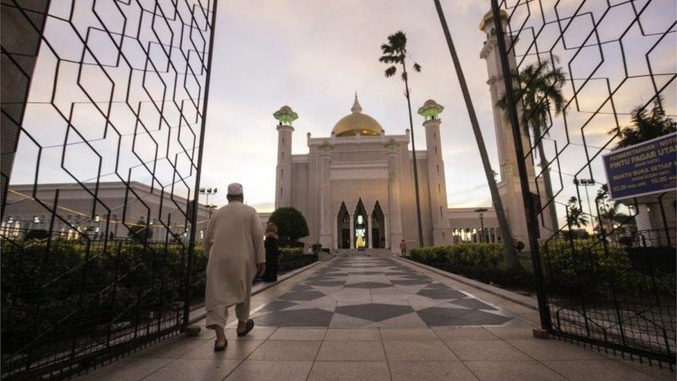 A Muslim man walks inside the Sultan Omar Ali Saifuddien mosque to perform the sunset prayer in Bandar Seri Begawan, Brunei, 1 April 2019