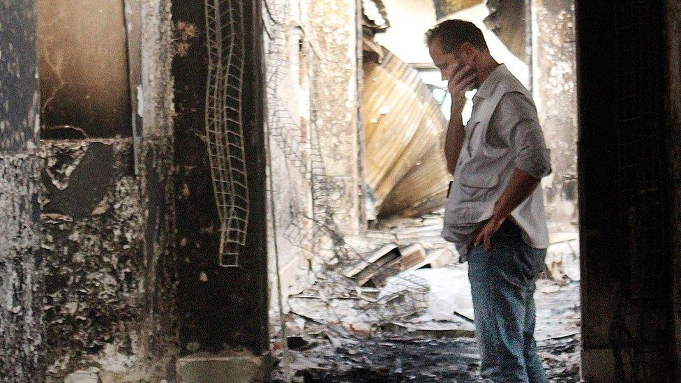 MSF employee inspects damaged clinic