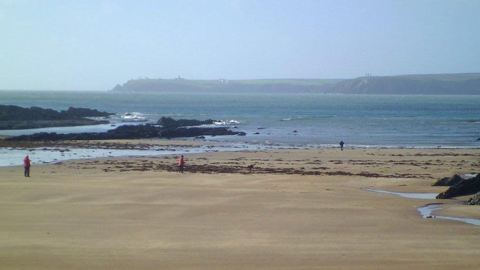 Beach with sand rocks and sea