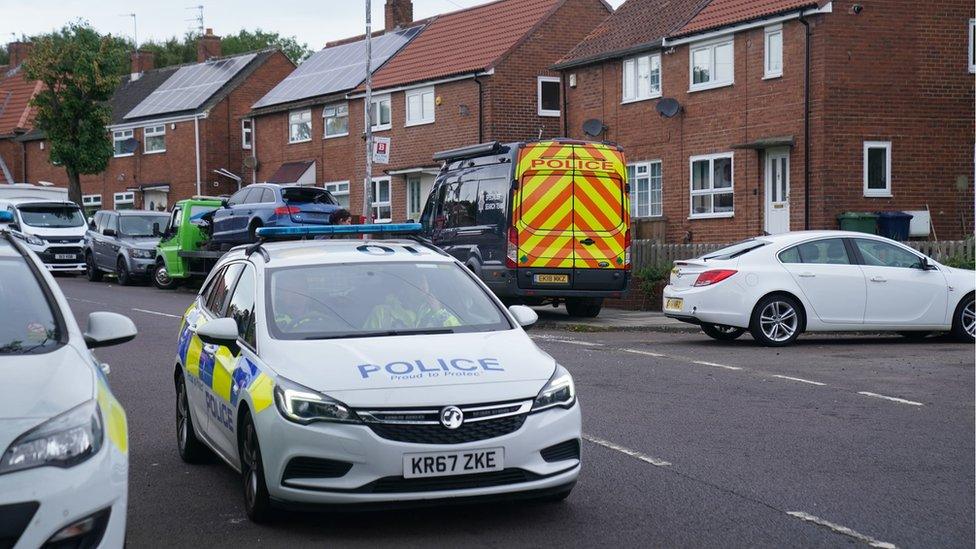 Police cars on a street nearby