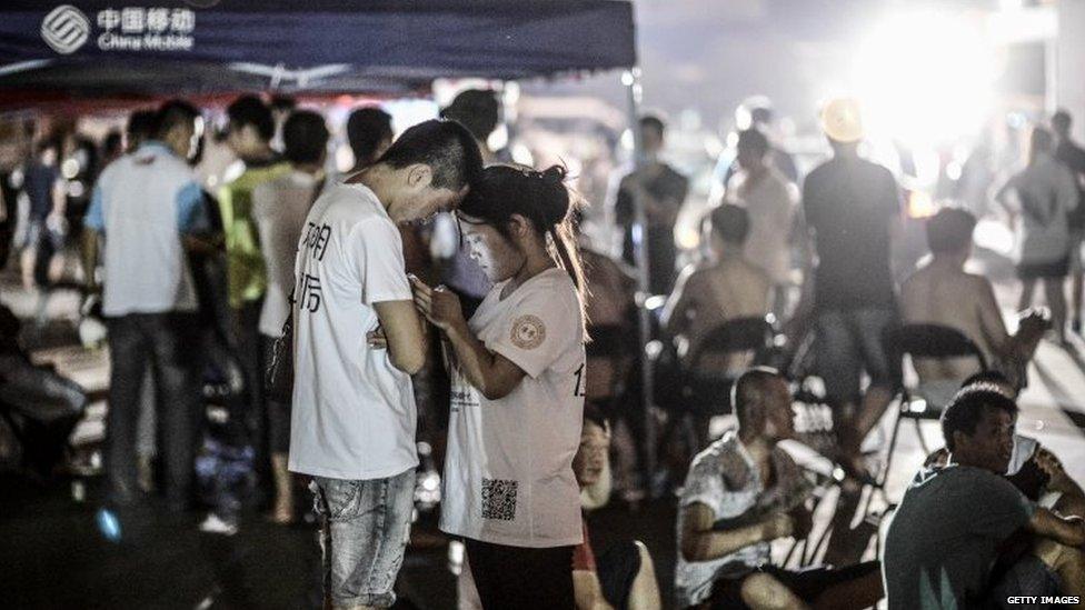 People stay at the emergency shelter set at a primary school on August 13, 2015 in Tianjin, China.