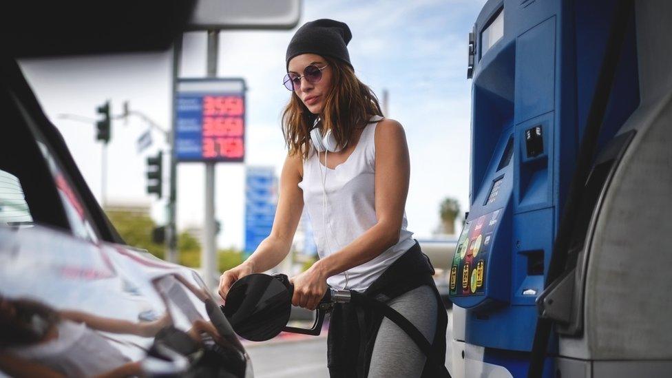 woman filling car with petrol