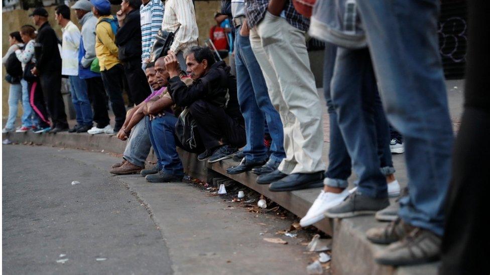 People waiting to board a bus