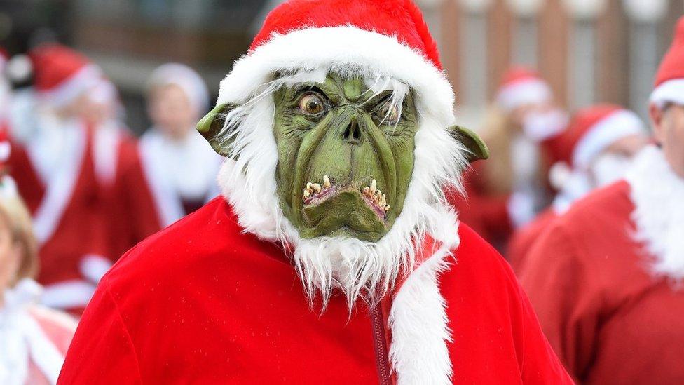 A runner dressed as The Grinch takes part in a Santa Dash in Liverpool