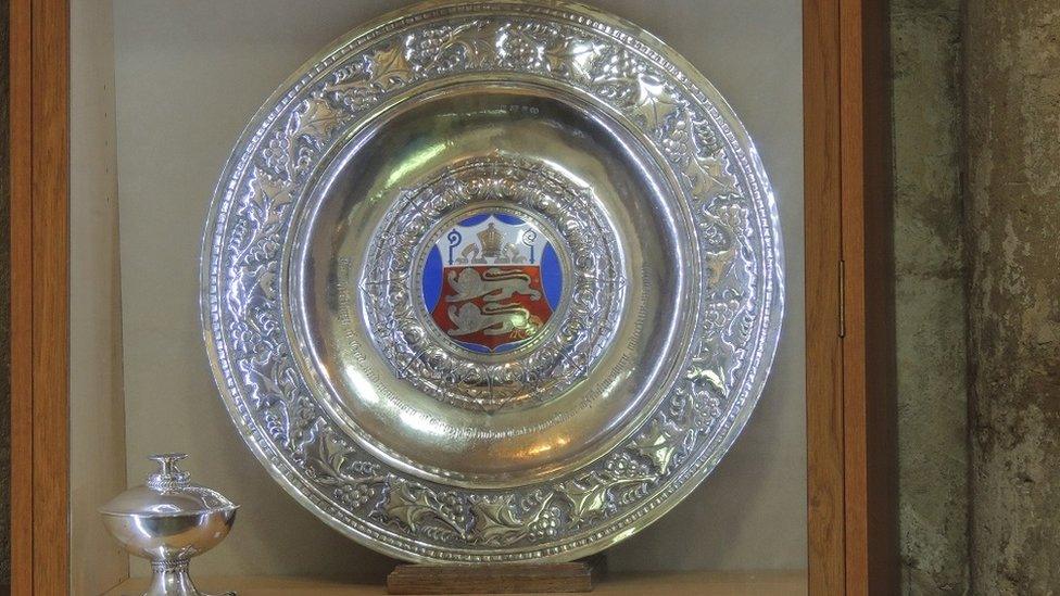 Decorative large silver plate and cup, with the plate having an enamel coat of arms in the middle