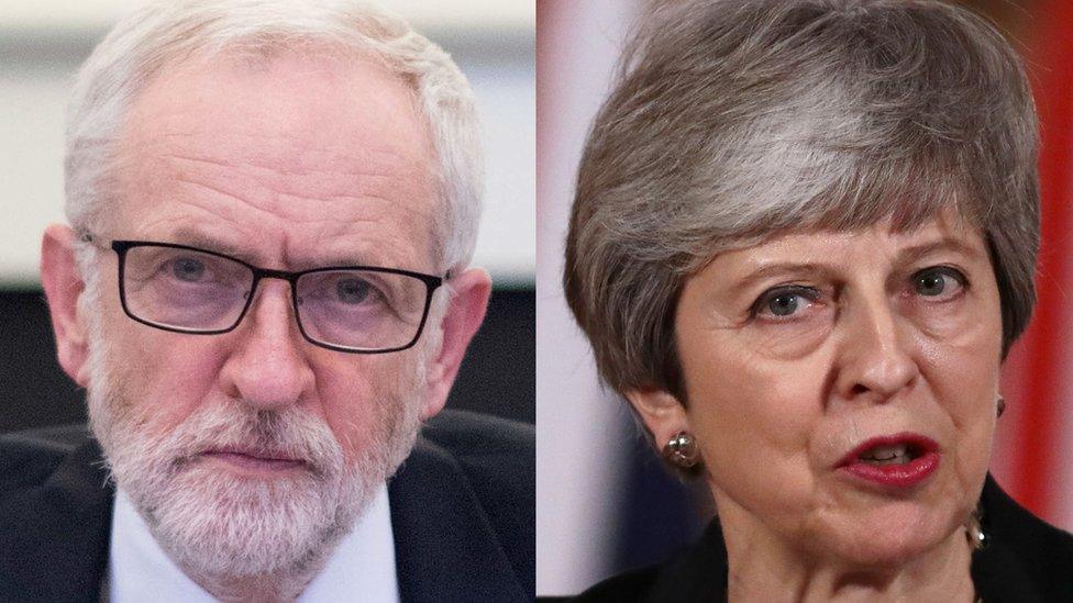 Jeremy Corbyn alongside a picture of Theresa May.