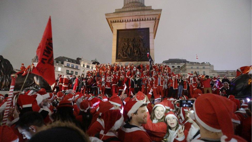 Revellers in Trafalgar Square, London, taking part in the Santacon Christmas parade. 10 December 2016