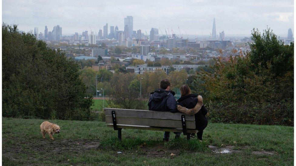 A couple take in the view at London's Parliament Hill in November 2019