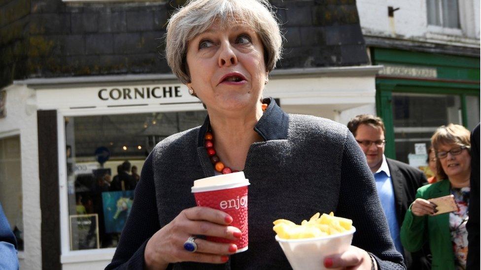 Theresa May eating chips