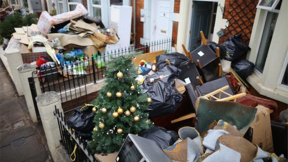 Water damaged possessions sit outside a flooded home in Carlisle