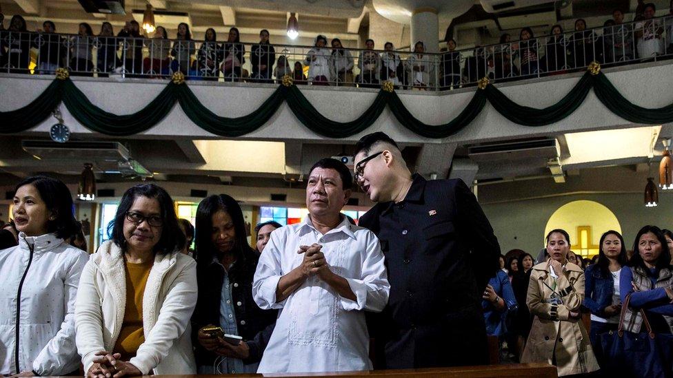 A Philippine President Rodrigo Duterte impersonator (centre left), who goes by the name Cresencio Extreme, listens to a North Korean leader Kim Jong-un impersonator (centre right), who goes by the name Howard X, as they attend a church service in the Central district of Hong Kong, 3 February 2019