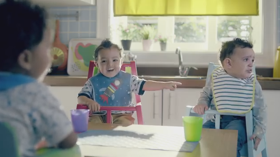 A grab from the advert showing one toddler teasing another toddler