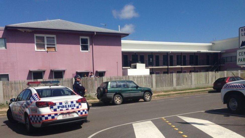 Police outside Shelley's Backpackers in north Queensland, Australia