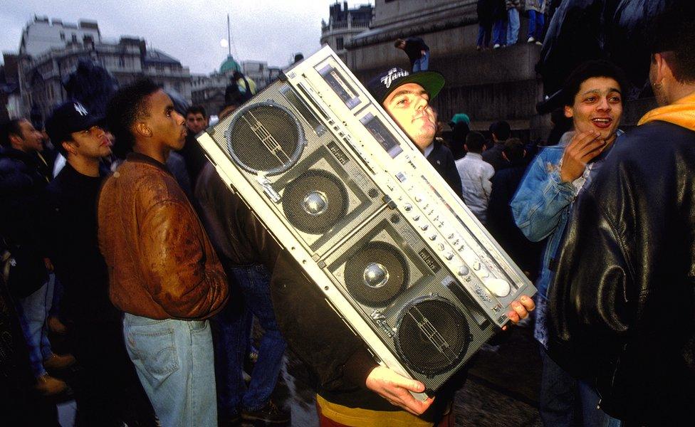 Protestor at 'Freedom to Party' demonstration carrying a tape deck Trafalgar Square London 1990