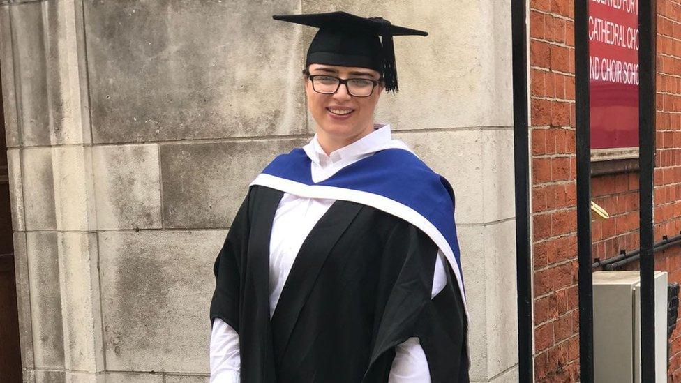 Chelsea in her graduation cap and gown smiling