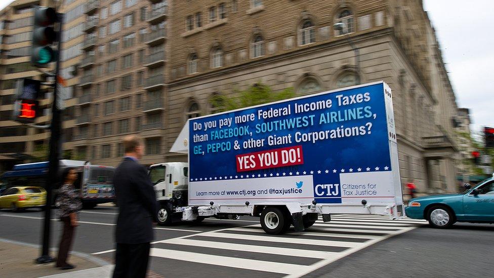 A rolling billboard sponsored by Citizens for Tax Justice (CTJ), reading: 'Do you pay more Federal Income Taxes than Facebook, Southwest Airlines, GE, Pepco and other Giant Corporations? Yes You Do!' A CTJ report, 'Ten Reasons We Need Corporate Tax Reform,' crosses an intersection April 15, 2013 in Washington, DC.