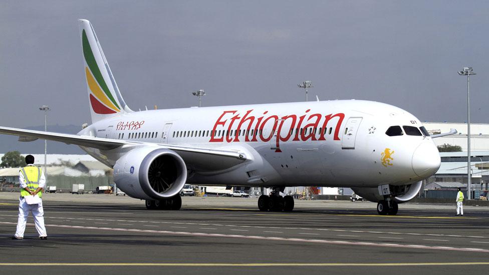 A member of the ground crew directs an Ethiopian Airlines plane at the Bole International Airport in Ethiopia's capital Addis Ababa, August 21, 2015.