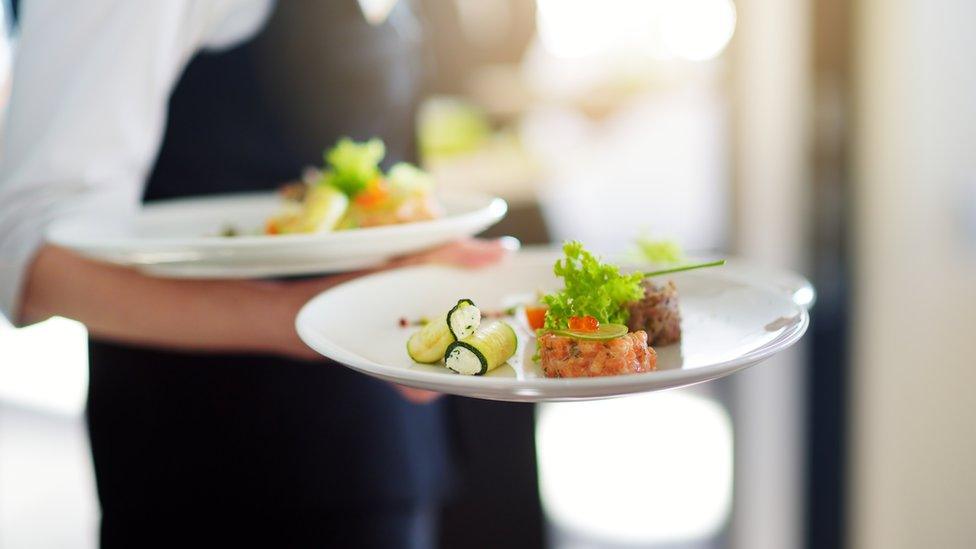 Waitress holding two plates