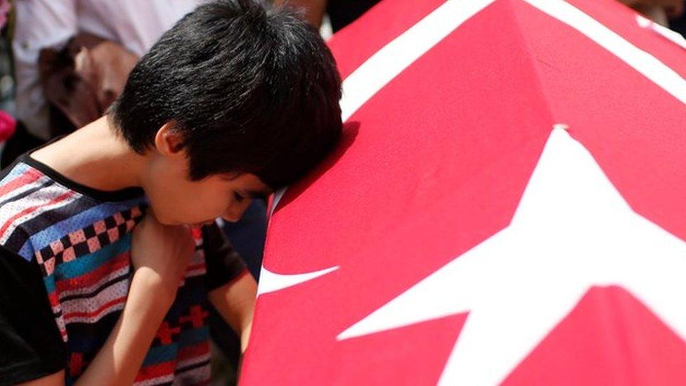 Relatives of a victim of the attack at Istanbul's airport mourn during a funeral on 30 June