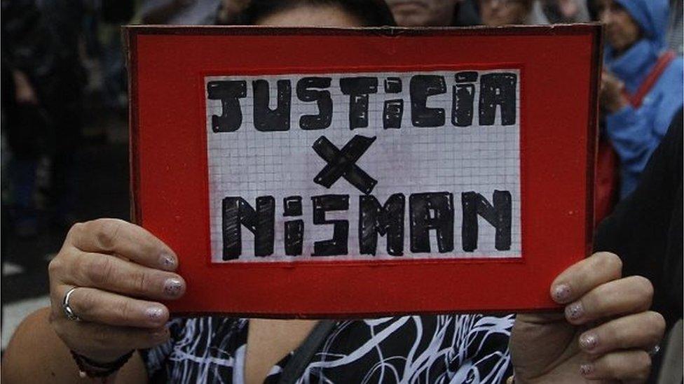 A woman holds a banner reading "Justice for Nisman" during a demonstration called by Argentine prosecutors in memory of their late colleague Alberto Nisman in Buenos Aires on 18 February, 2015.