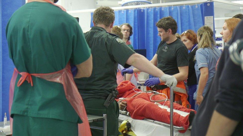 A trauma team attending a patient in the Resus unit at King' s College Hospital