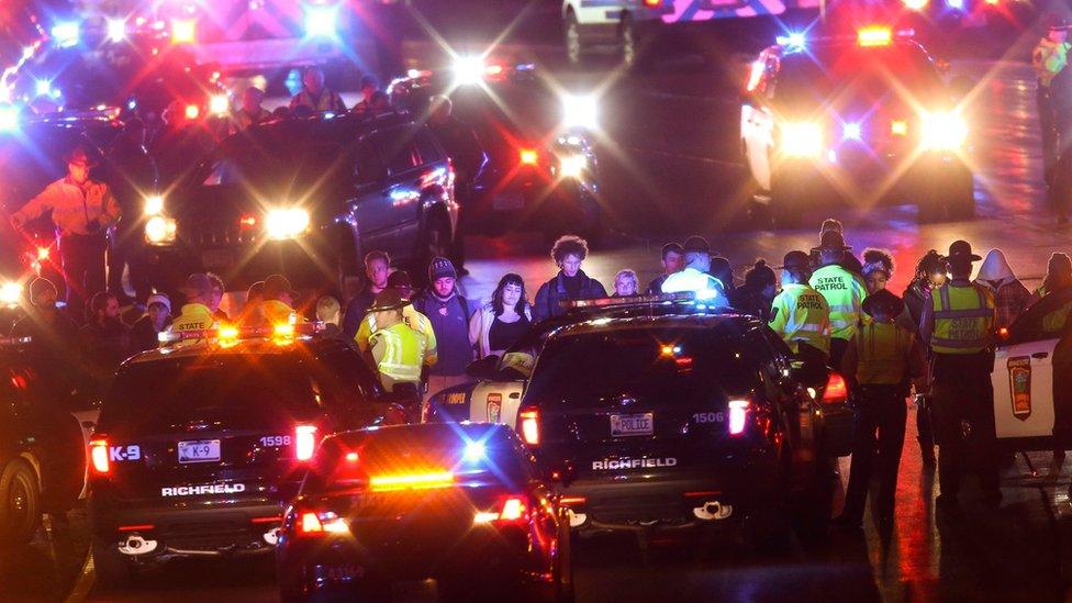 Protesters form a line blacking the highway in Minneapolis