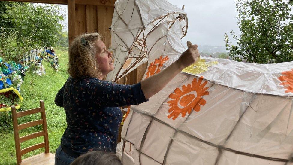 Woman decorating parts for the bee