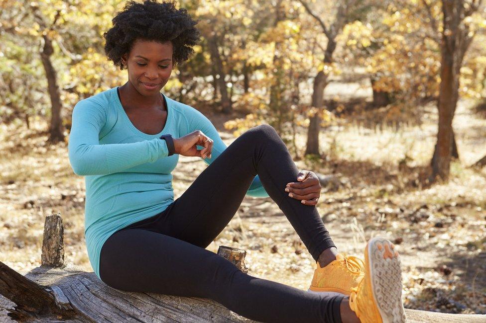 Female runner checking smartwatch