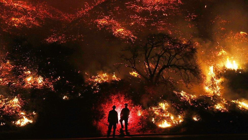 Firefighters monitor a section of the Thomas Fire along the 101 freeway on December 7, 2017 north of Ventura, California.