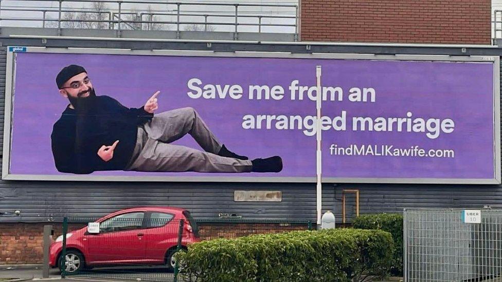 A bill board with an image of Muhammad Malik with the caption 'Save me from an arranged marriage'