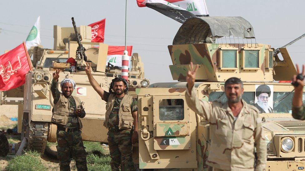 A picture of Iran's Supreme Leader Ayatollah Ali Khamenei (R) adorns a military vehicle as Iraqi troops and Shia militiamen are deployed north-west of Baghdad on 26 May 2015