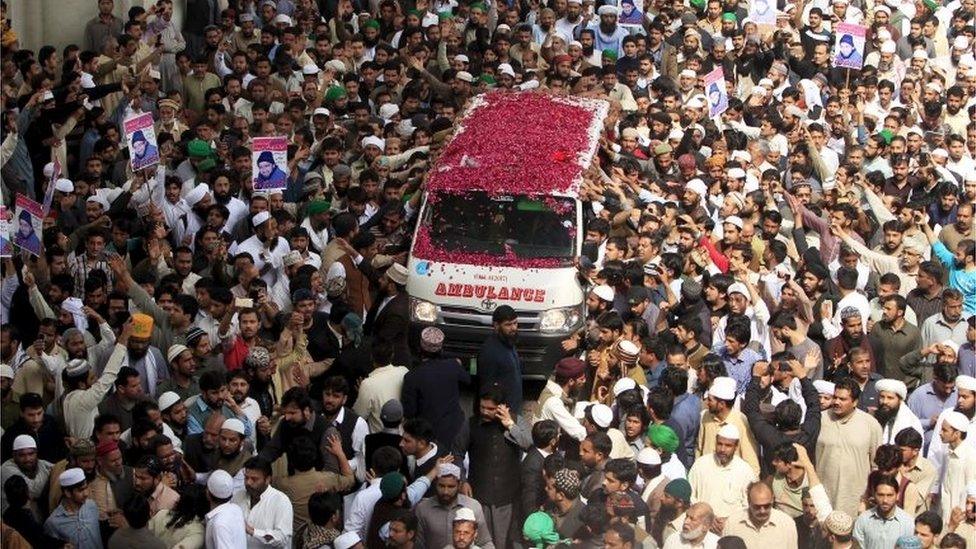 Supporters of Mumtaz Qadri shower rose pastels on an ambulance carrying the body of Qadri for funeral in Rawalpindi, Pakistan, March 1, 2016.